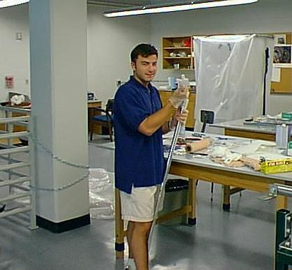 Dr. Dave Schroerlucke working in physics lab