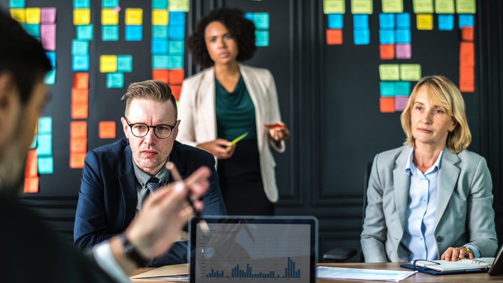 business consultant presenting to small team of professionals