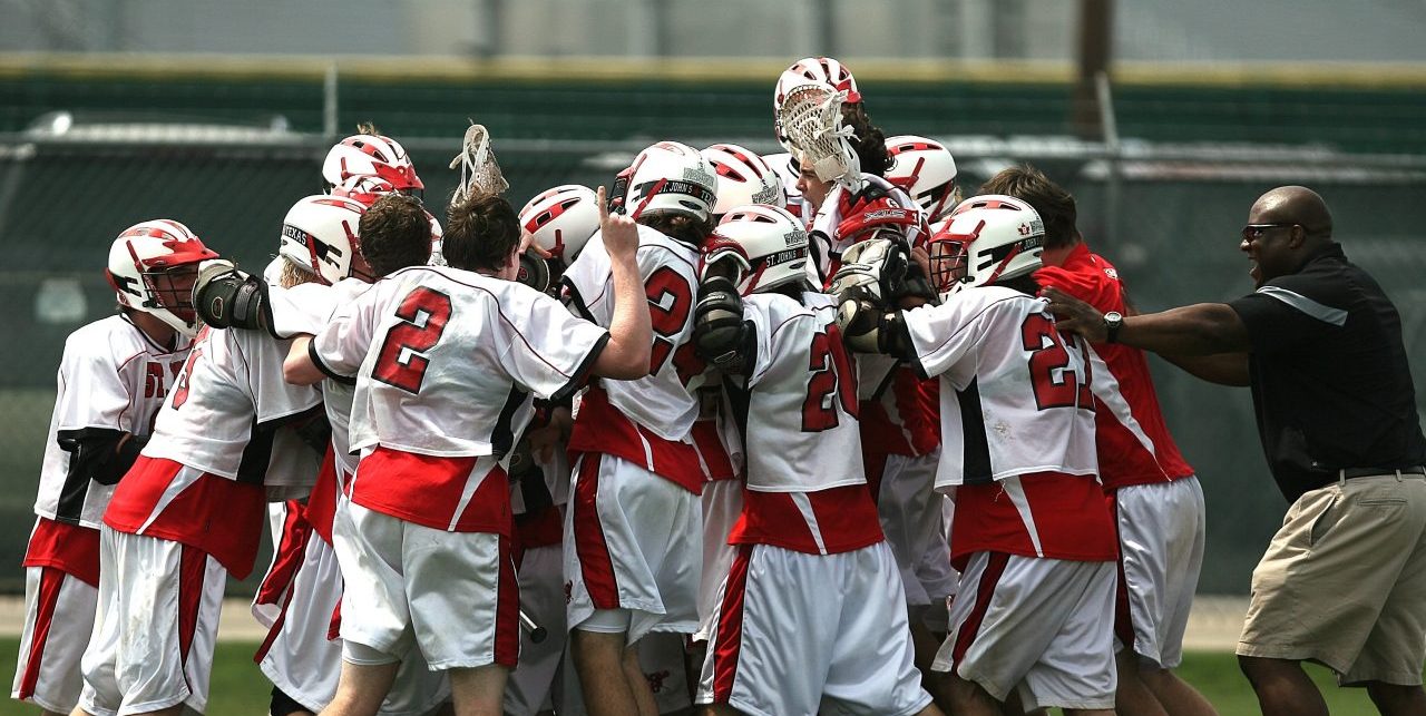 youth lacrosse team celebrating achievement